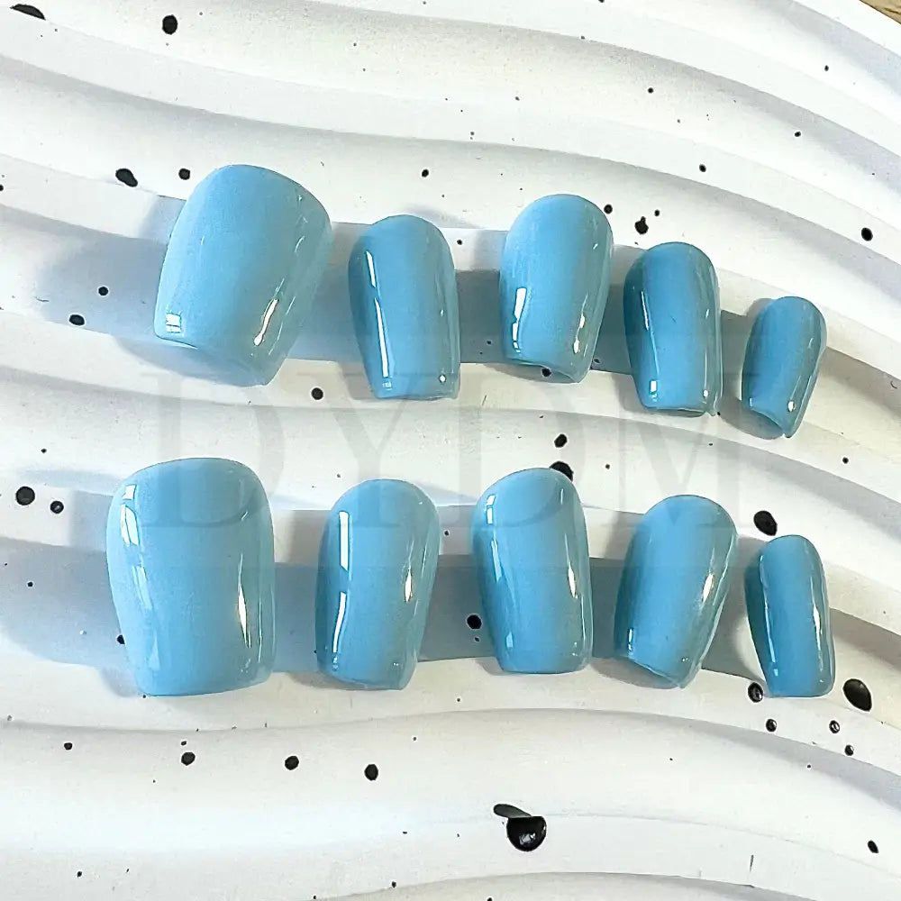 Baby Blue Bliss handmade press on nails, featuring a charming and sweet baby blue color reminiscent of a delightful macaroon. The soft and pastel hue adds whimsy and playfulness to your manicure, bringing a delectable touch of sweetness to your style