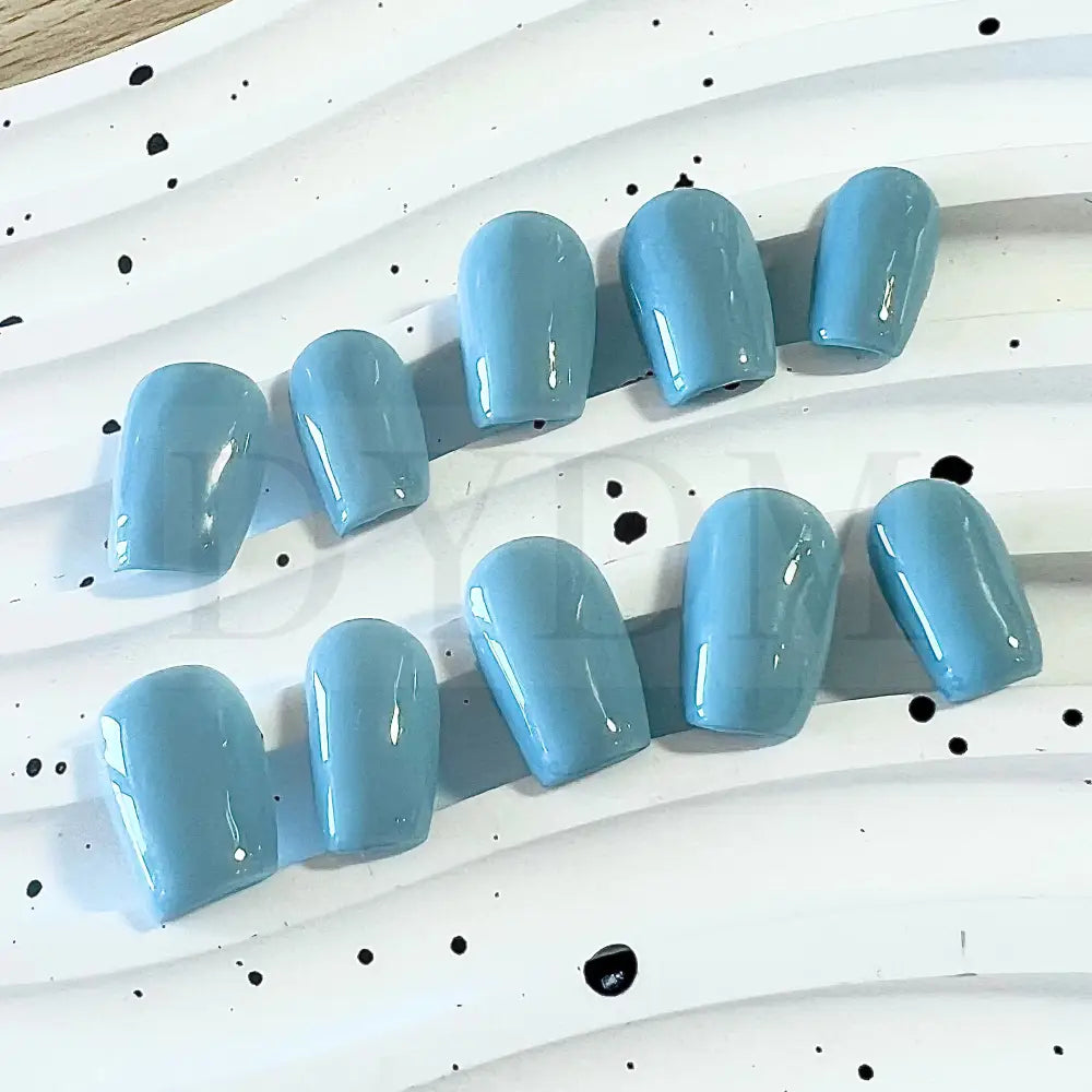 Baby Blue Bliss handmade press on nails, featuring a charming and sweet baby blue color reminiscent of a delightful macaroon. The soft and pastel hue adds whimsy and playfulness to your manicure, bringing a delectable touch of sweetness to your style