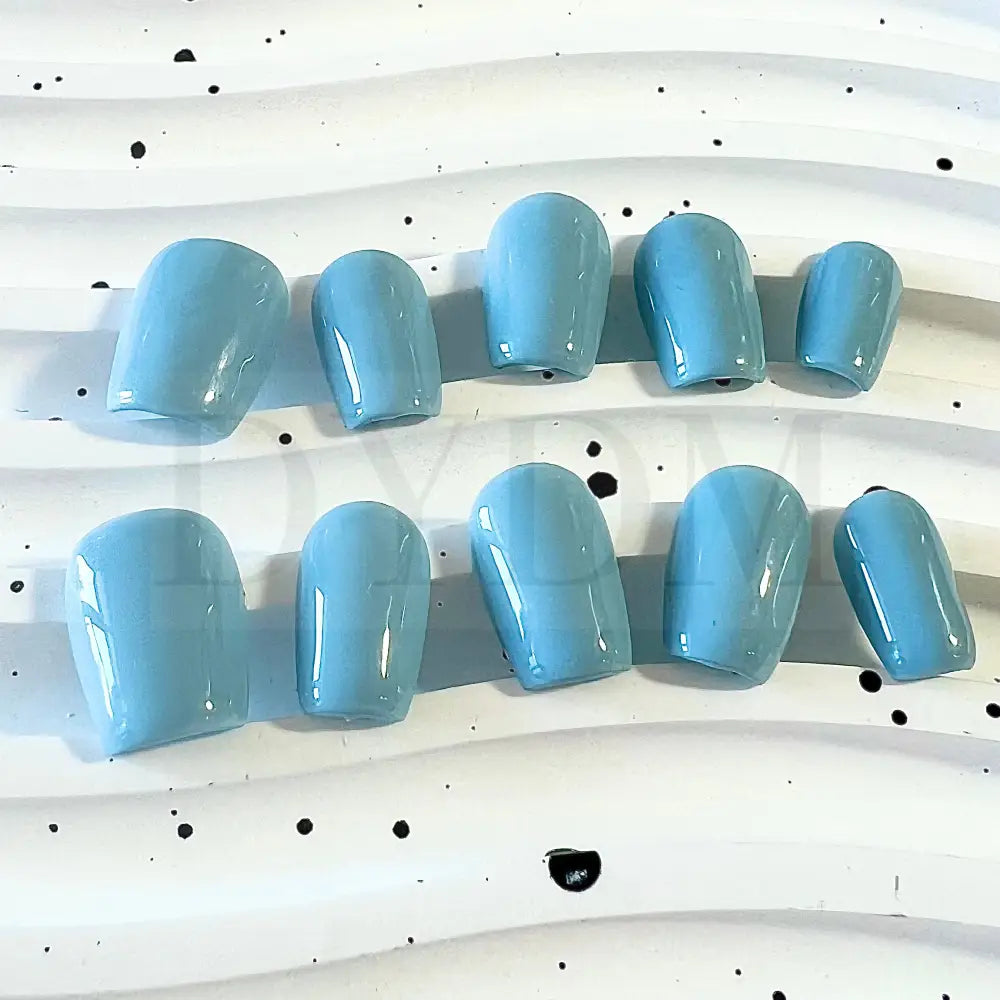 Baby Blue Bliss handmade press on nails, featuring a charming and sweet baby blue color reminiscent of a delightful macaroon. The soft and pastel hue adds whimsy and playfulness to your manicure, bringing a delectable touch of sweetness to your style