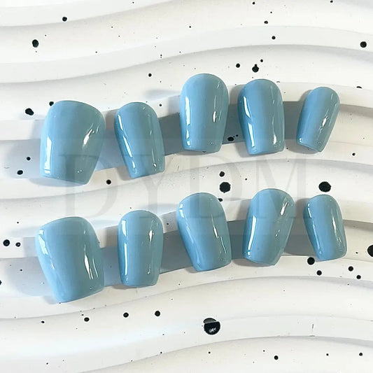 Baby Blue Bliss handmade press on nails, featuring a charming and sweet baby blue color reminiscent of a delightful macaroon. The soft and pastel hue adds whimsy and playfulness to your manicure, bringing a delectable touch of sweetness to your style