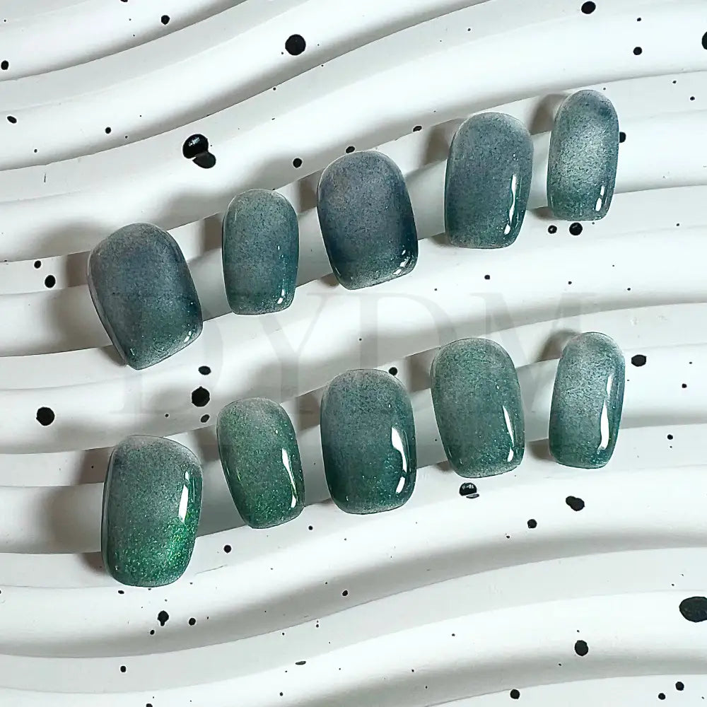 Emerald Shimmer cat eye handmade press on nails, featuring rich emerald green hue and a mesmerizing cat eye effect