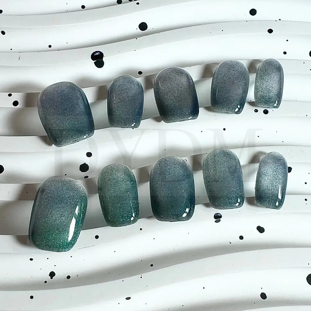 Emerald Shimmer cat eye handmade press on nails, featuring rich emerald green hue and a mesmerizing cat eye effect