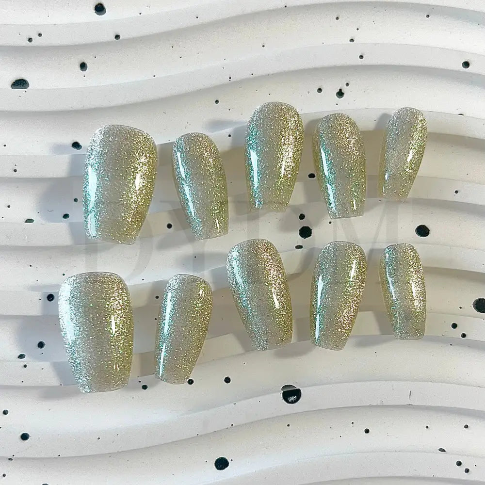 Lunar Radiance handmade press on nails showcases a silver cat eye effect that captures the essence of moonlit beauty.