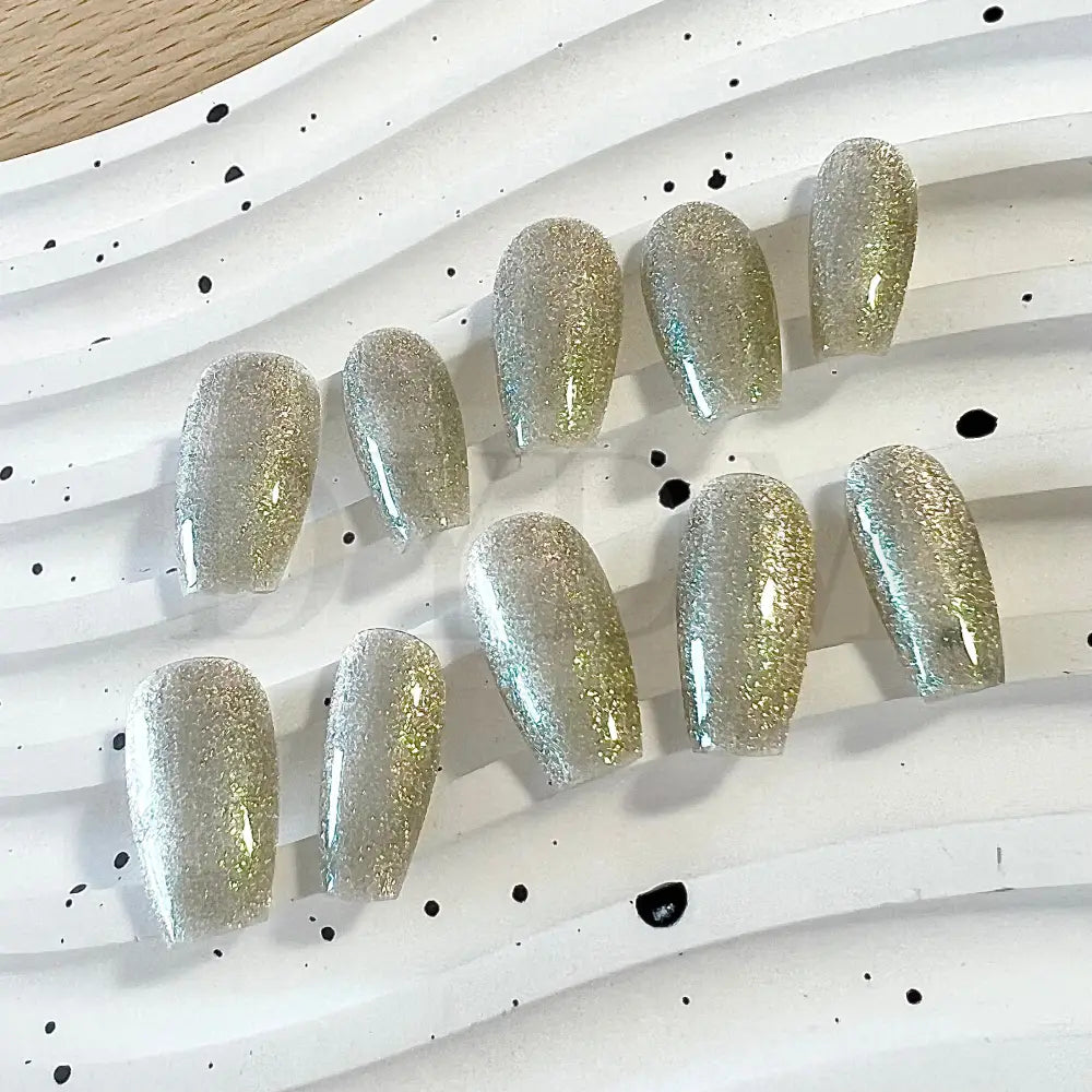 Lunar Radiance handmade press on nails showcases a silver cat eye effect that captures the essence of moonlit beauty.