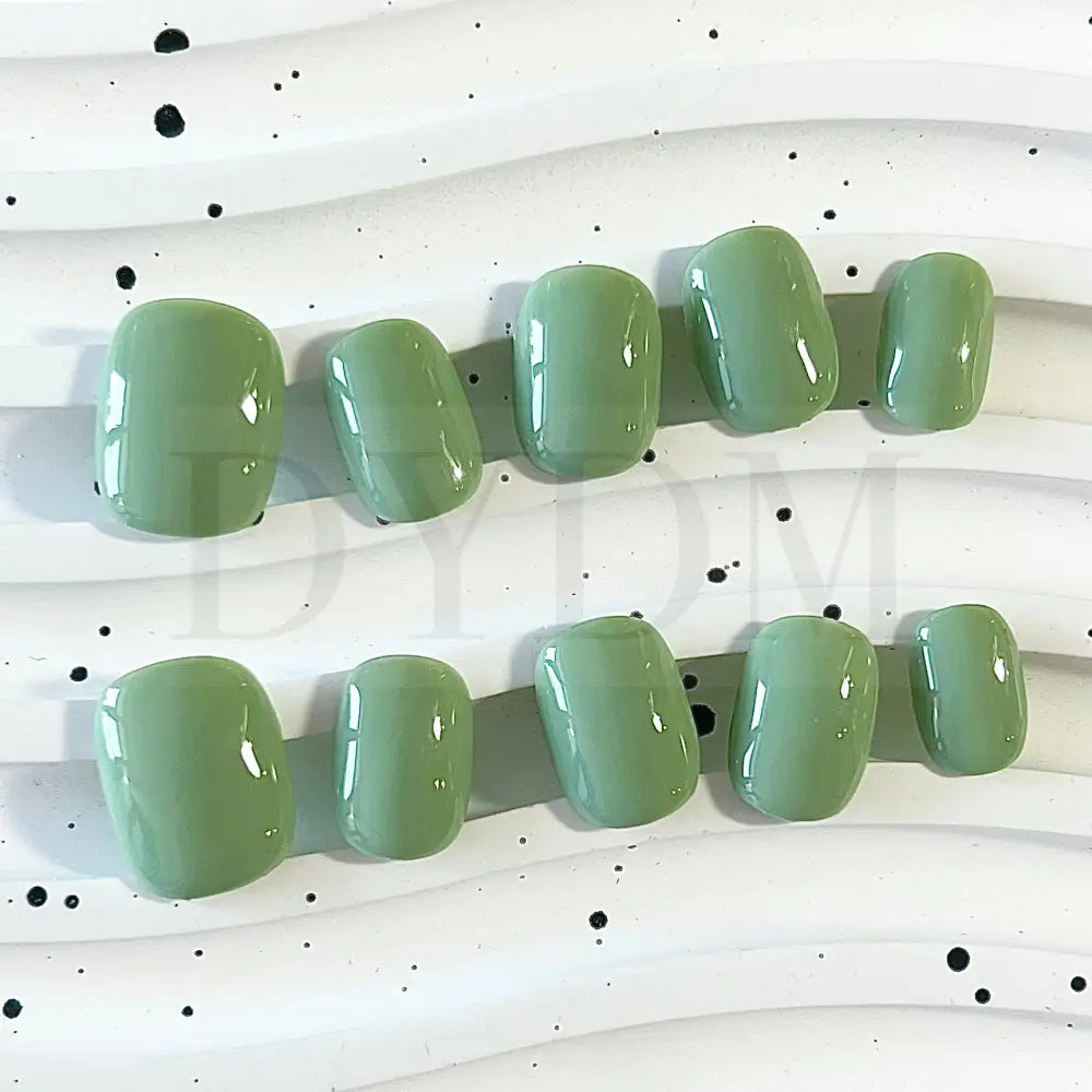 Minty Fresh handpainted press-on nails, featuring a refreshing and vibrant green color reminiscent of a delightful mint macaroon. These nails exude a cool and invigorating essence, adding a touch of vibrancy and sophistication to your fingertips.