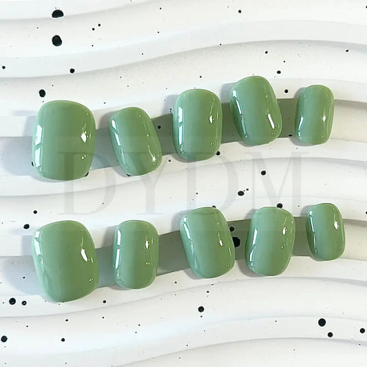 Minty Fresh handpainted press-on nails, featuring a refreshing and vibrant green color reminiscent of a delightful mint macaroon. These nails exude a cool and invigorating essence, adding a touch of vibrancy and sophistication to your fingertips.