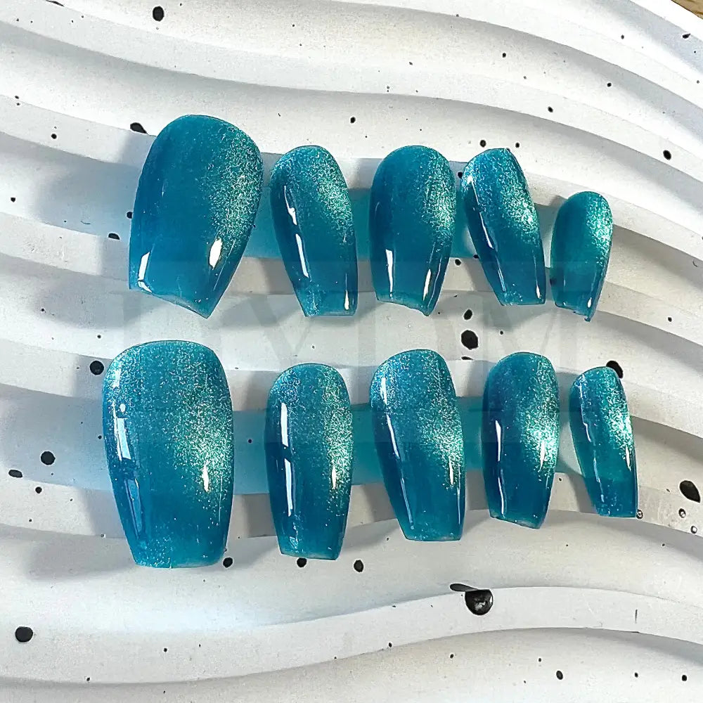 Oceanic Azure handmade press on nails feature a captivating blend of blue and turquoise tones, creating a mesmerizing cat eye effect.