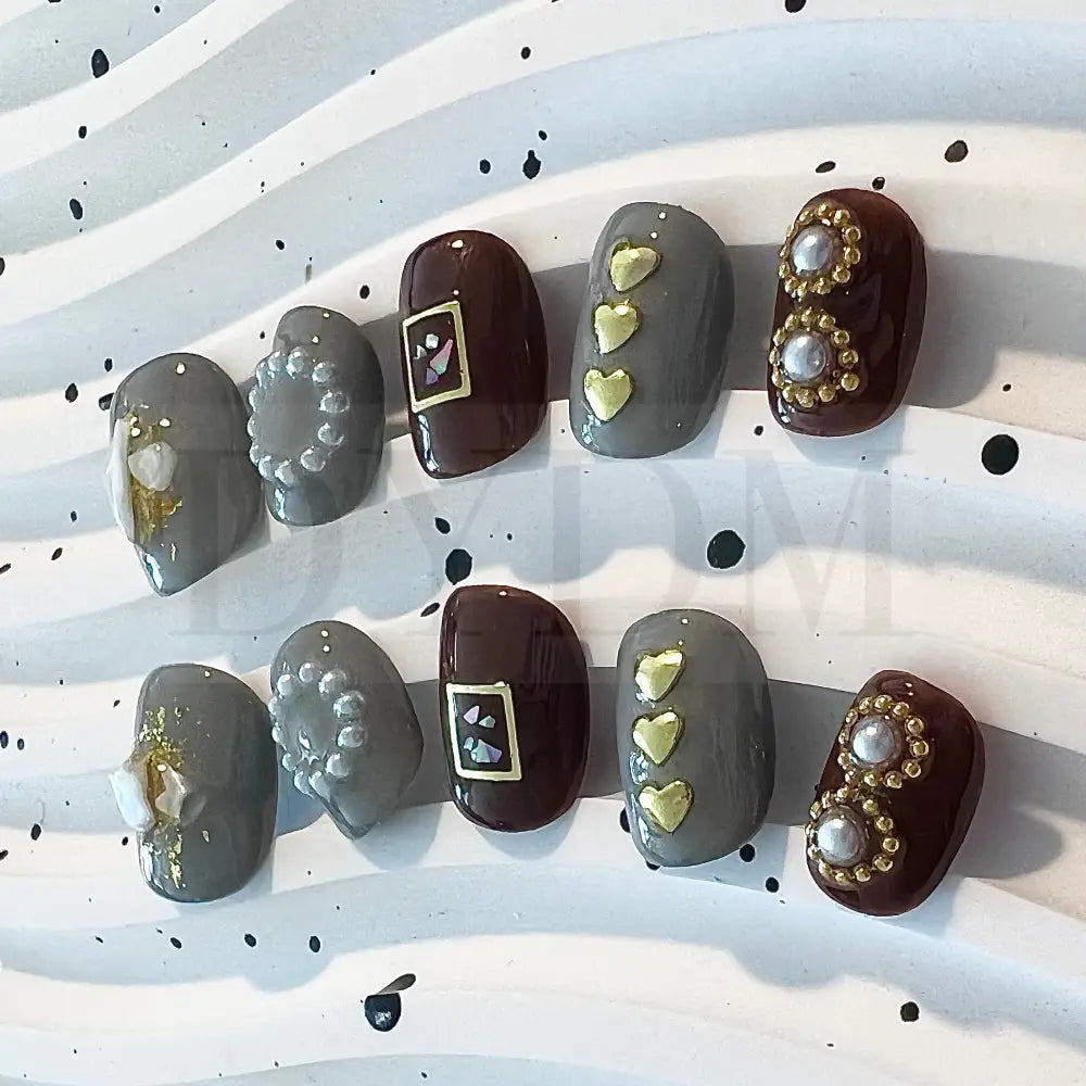 Coffee Fantasy enhance your style with these chic short round nails in gray and brown shades, featuring charming heart-shaped embellishments and delicate pearls