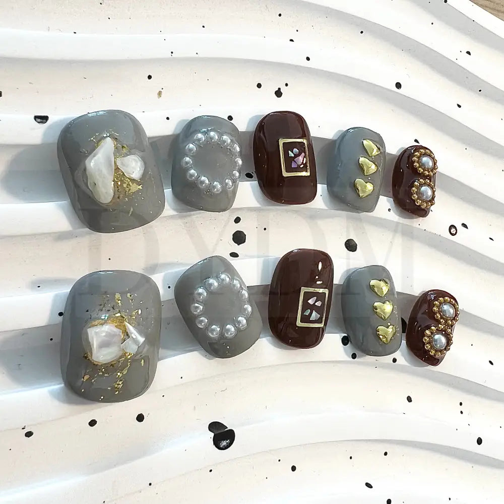 Coffee Fantasy enhance your style with these chic short round nails in gray and brown shades, featuring charming heart-shaped embellishments and delicate pearls