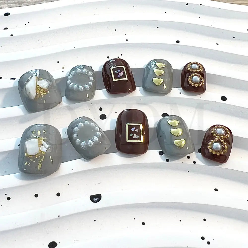 Coffee Fantasy enhance your style with these chic short round nails in gray and brown shades, featuring charming heart-shaped embellishments and delicate pearls