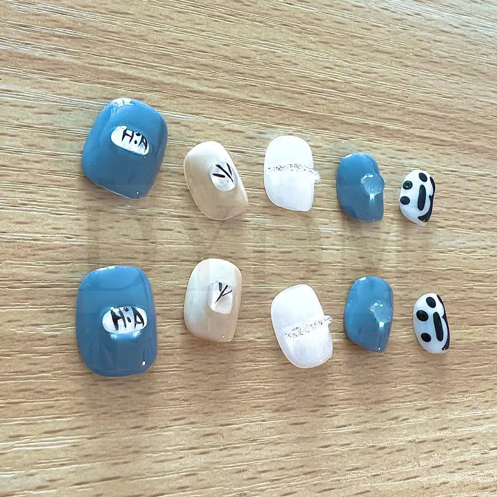 Dainty Gems Featuring a bold combination of blue, white, and black, adorned with dainty gems, these handmade reusable press on nails are the perfect choice to add a pop of color and playfulness to your look.