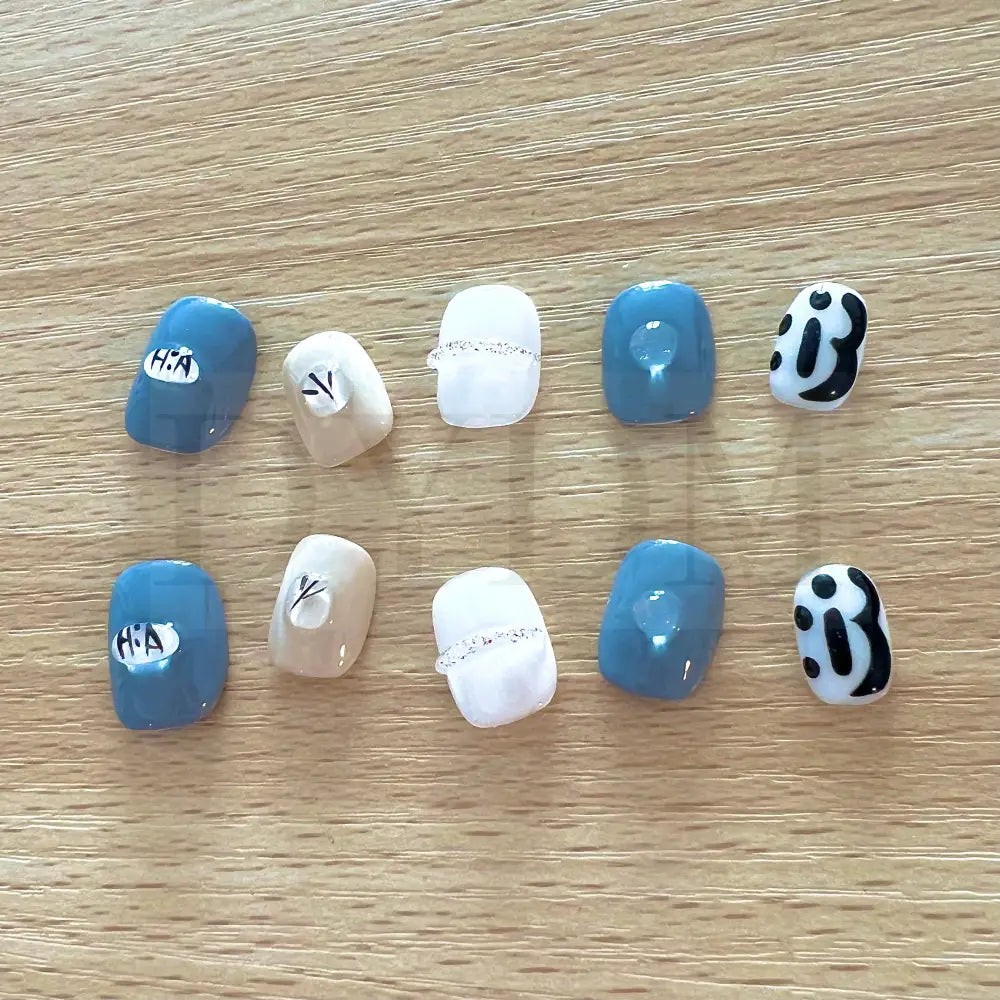 Dainty Gems Featuring a bold combination of blue, white, and black, adorned with dainty gems, these handmade reusable press on nails are the perfect choice to add a pop of color and playfulness to your look.