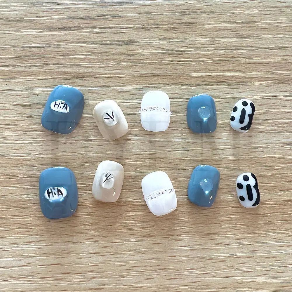 Dainty Gems Featuring a bold combination of blue, white, and black, adorned with dainty gems, these handmade reusable press on nails are the perfect choice to add a pop of color and playfulness to your look.