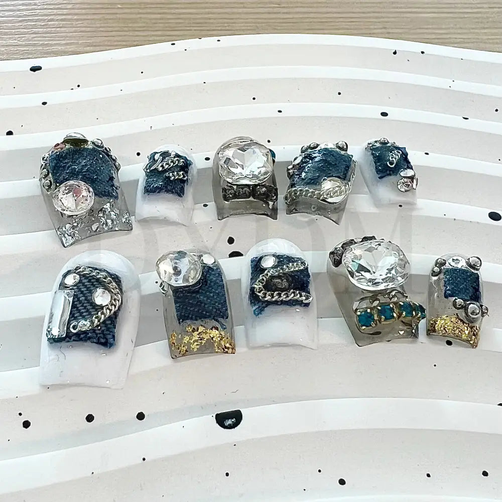 Denim Delight Adorned with intricate denim patch designs and dazzling gemstones, these denim-inspired handmade press-on nails create a trendy and glamorous vibe.