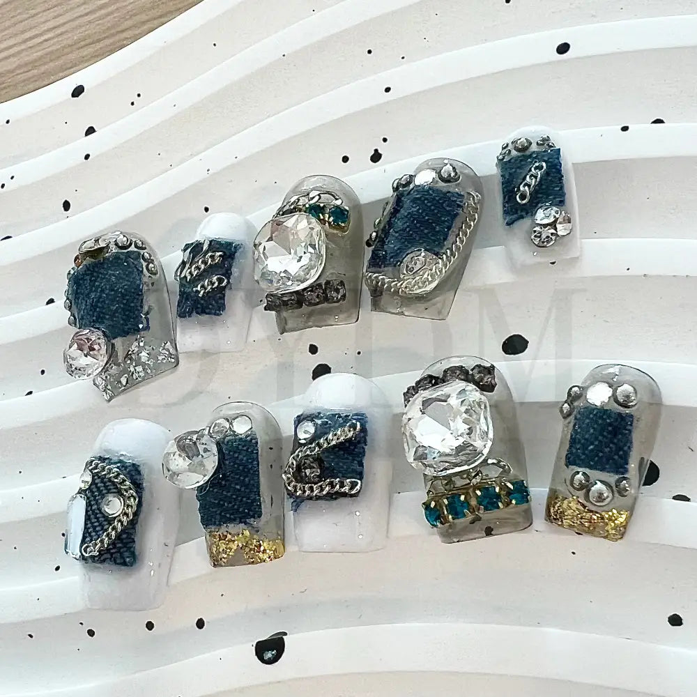 Denim Delight Adorned with intricate denim patch designs and dazzling gemstones, these denim-inspired handmade press-on nails create a trendy and glamorous vibe.