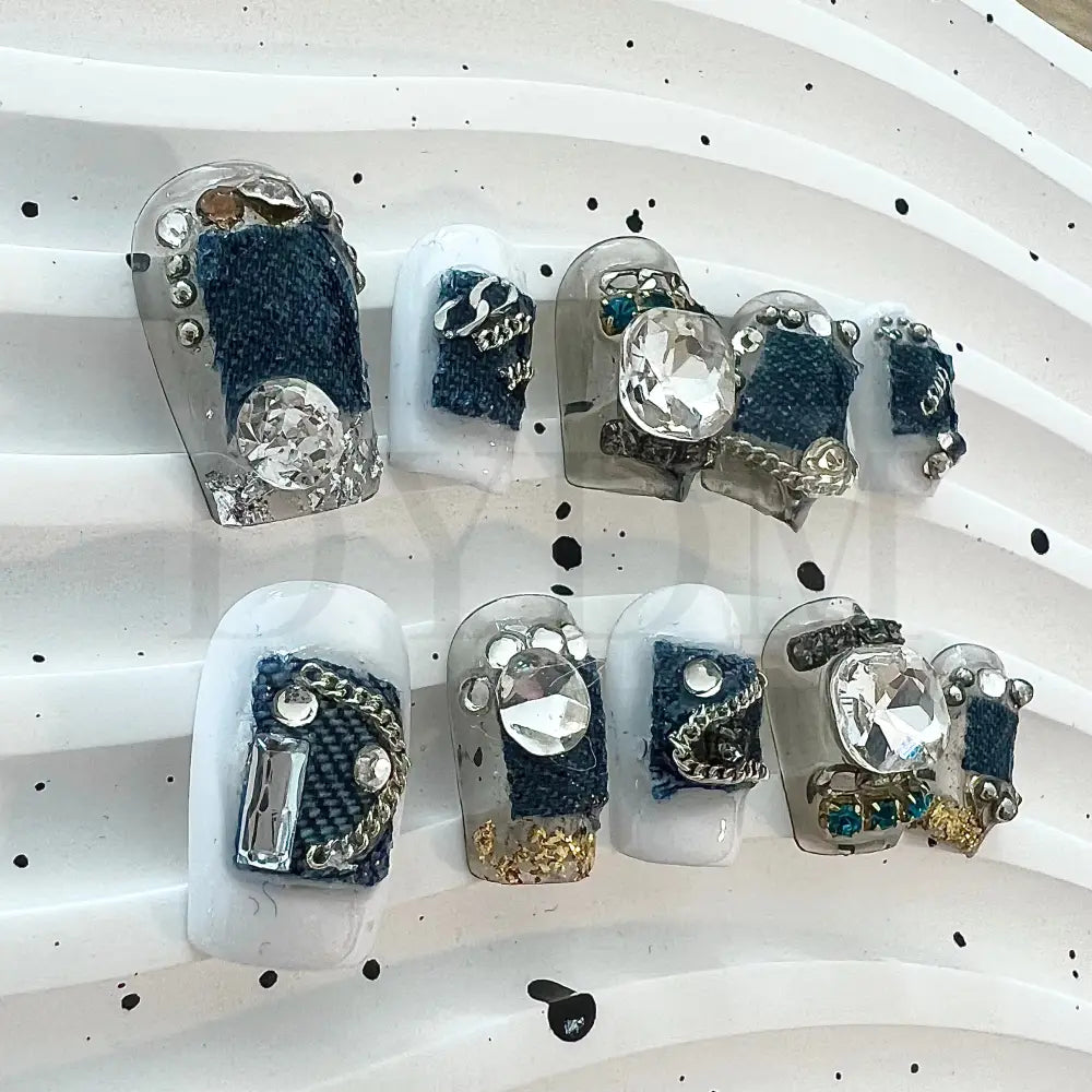 Denim Delight Adorned with intricate denim patch designs and dazzling gemstones, these denim-inspired handmade press-on nails create a trendy and glamorous vibe.